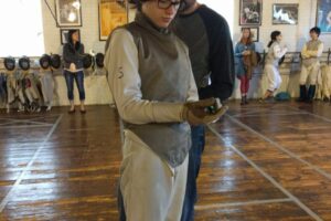 Greta Tart, women's foil, with parent dad, tournament