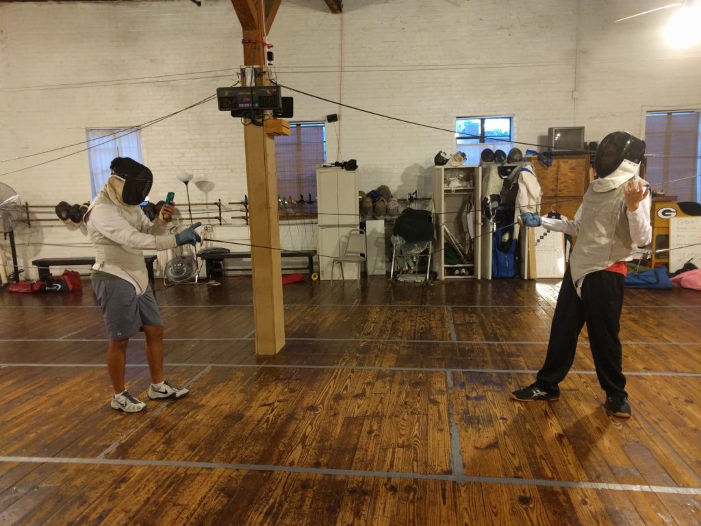 fencer on cell phone
